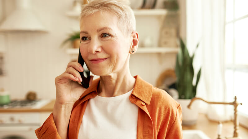 Older woman holding a phone up to her ear