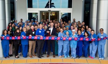 People cutting a ribbon to open West Henderson Hospital