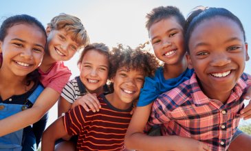 A group of children smiling at the camera.