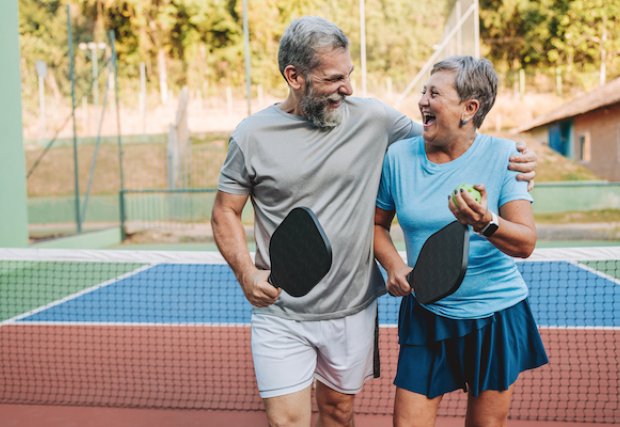 A man and woman playing pickleball