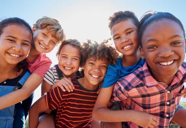 A group of children smiling at the camera.